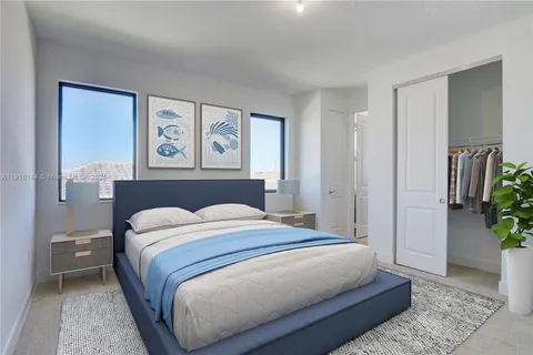 a bedroom with a bed and painting on the wall