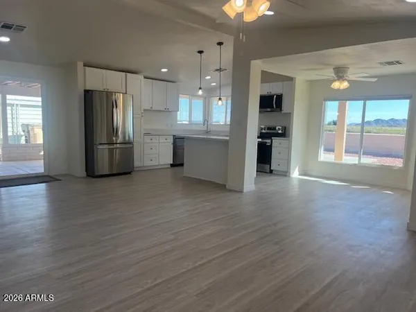 a view of a kitchen with a sink and a refrigerator