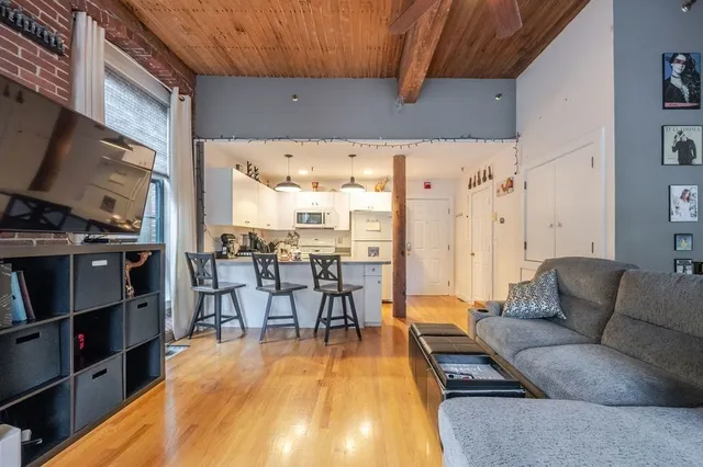 a kitchen with cabinets appliances a sink and a counter top space