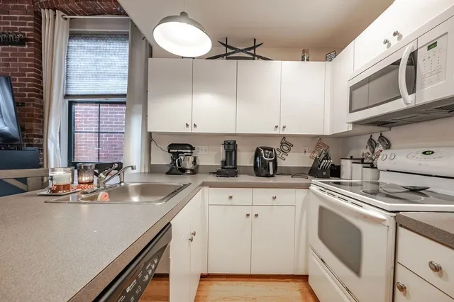 a kitchen with sink a stove and cabinets