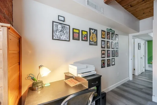 a bedroom with a bed and a lamp on the dresser