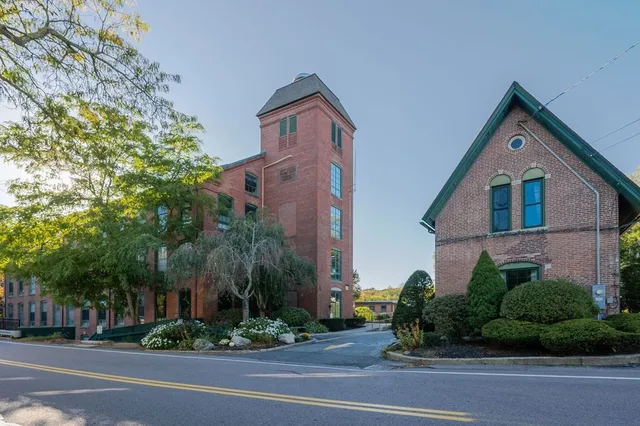 a view of a backyard with table and chairs potted plants and wooden fence