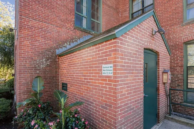 a living room with furniture and a baby crib