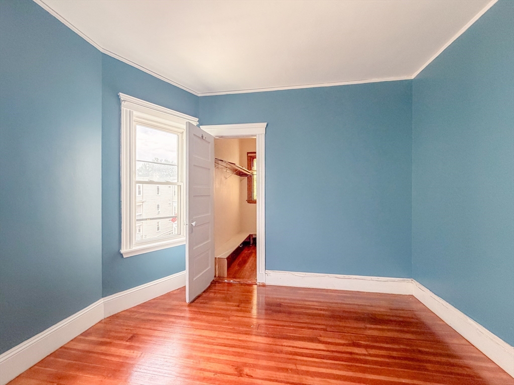 21 St Marks Road Boston, MA 02124 - Photo 18 of 30 a view of empty room with wooden floor and fan