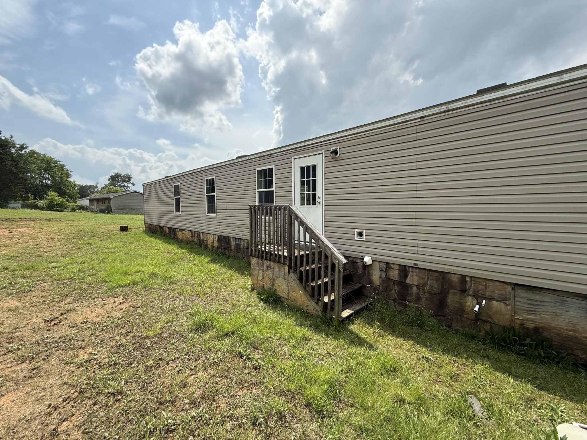 1001 Old Three Notch Road Ringgold, GA 30736 - Photo 23 of 26 a backyard of a house with wooden fence and a large tree