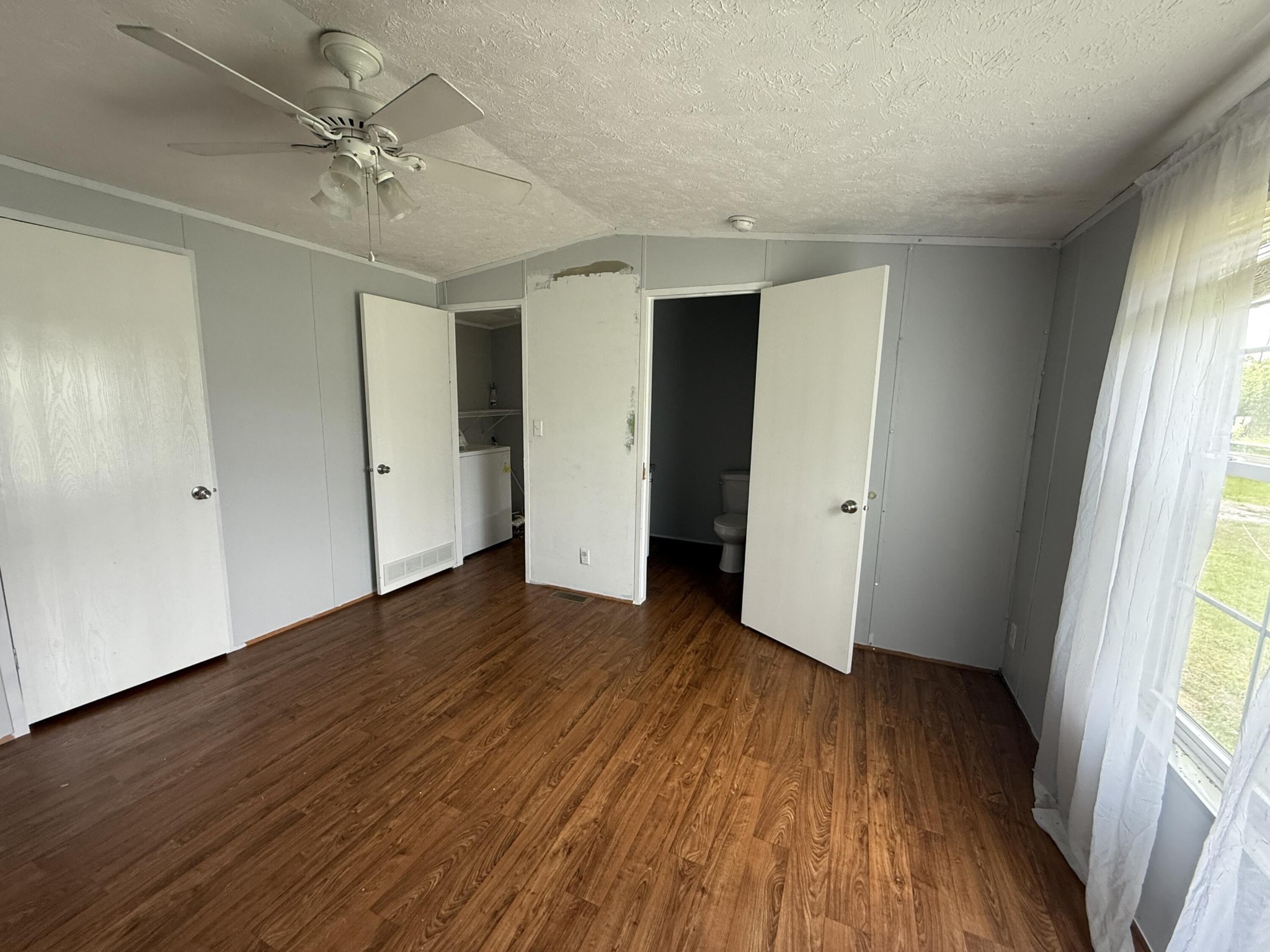 1001 Old Three Notch Road Ringgold, GA 30736 - Photo 10 of 26 an empty room with wooden floor and windows
