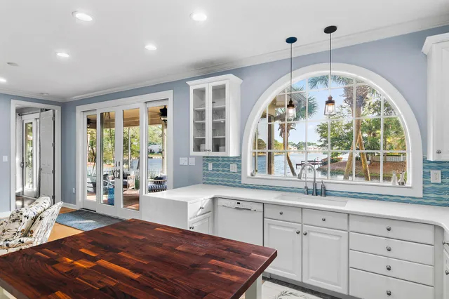 a kitchen with stainless steel appliances kitchen island granite countertop a stove a sink a refrigerator a microwave and cabinets