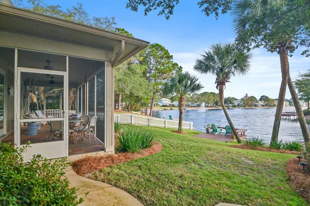 a view of a chairs on a deck with a lake view