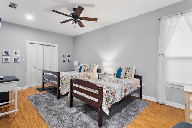 a bathroom with a granite countertop sink a toilet and a mirror