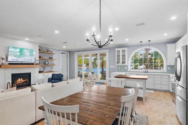 a living room with furniture fireplace and a large window