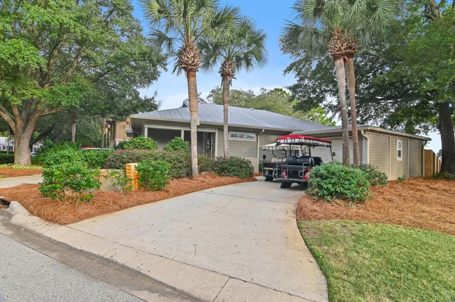 an aerial view of residential houses with outdoor space and lake view