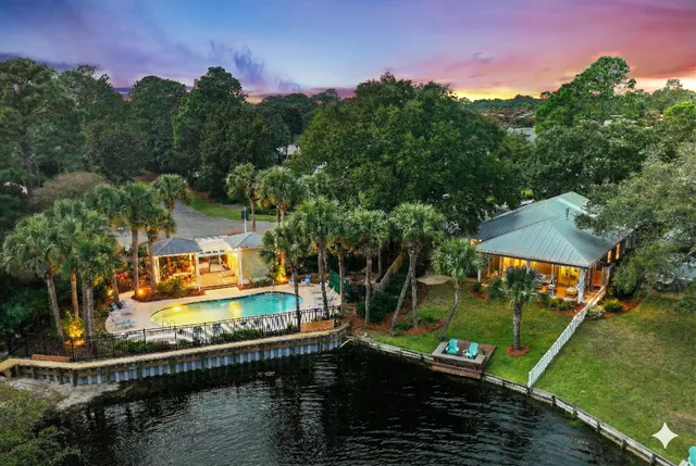 an aerial view of a house with swimming pool and garden