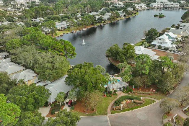 a view of a patio with table and chairs potted plants and palm tree
