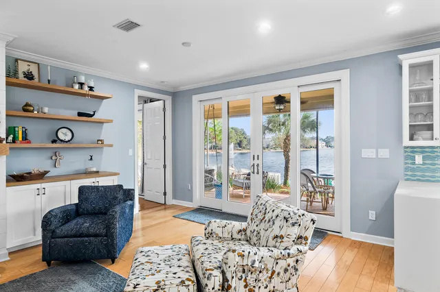 a living room with furniture a kitchen view and a fireplace