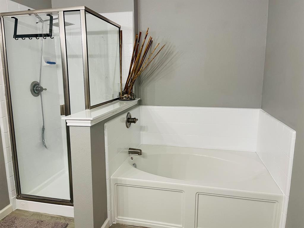 516 Angela Lane Euless, TX 76039 - Photo 20 of 39 Bathroom with a stall shower and a bath