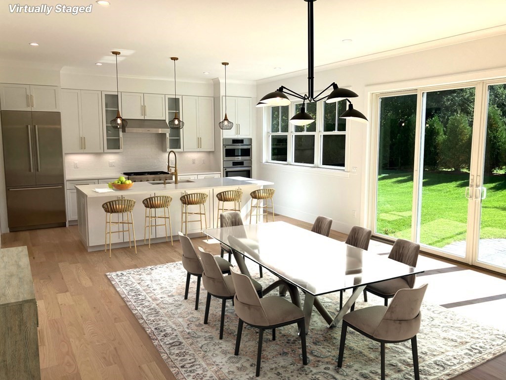 15 Woodside Road Framingham, MA 01701 - Photo 10 of 26 a kitchen that has a table chairs and a wooden floor