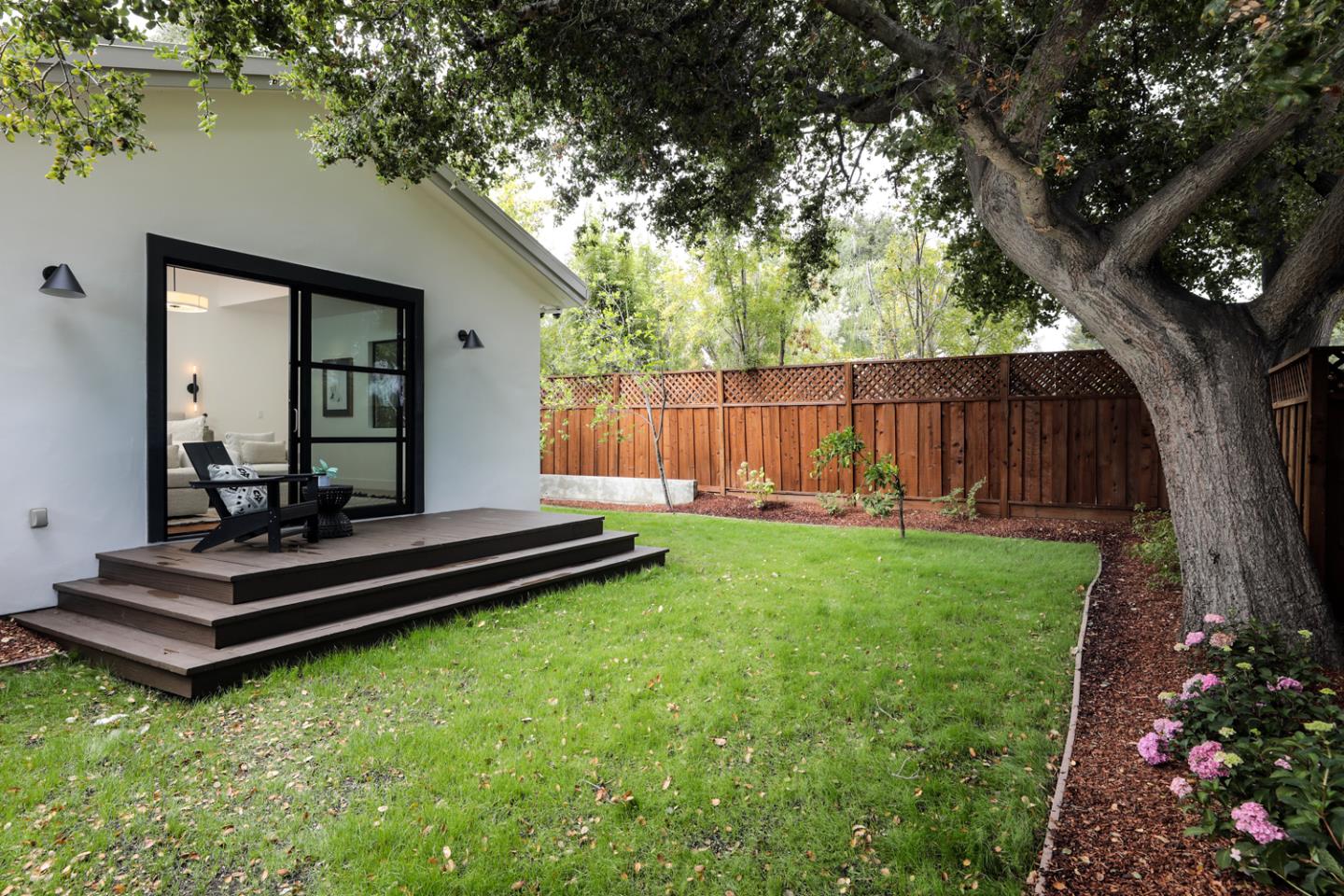 1136 Miramonte Avenue Los Altos, CA 94024 - Photo 30 of 58 a view of a backyard with wooden fence and a large tree