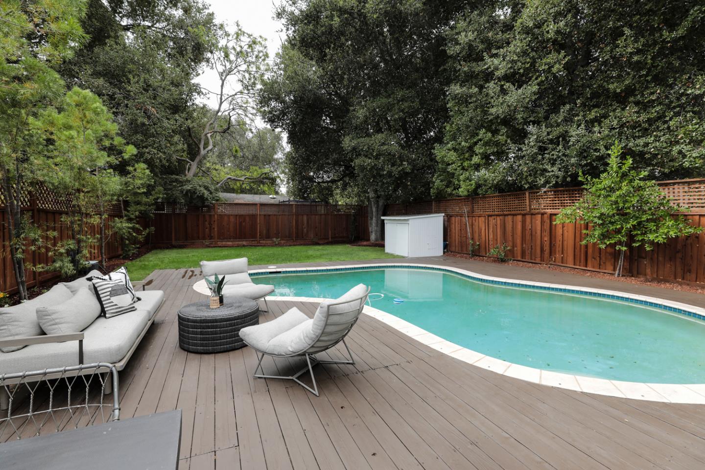 1136 Miramonte Avenue Los Altos, CA 94024 - Photo 39 of 58 a backyard of a house with barbeque oven table and chairs