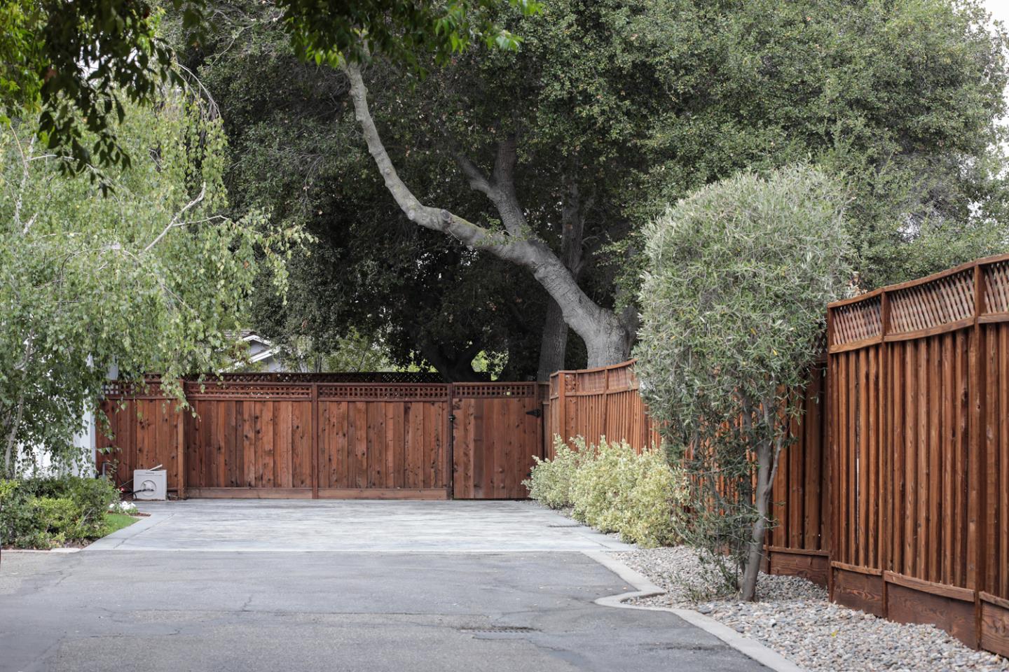 1136 Miramonte Avenue Los Altos, CA 94024 - Photo 56 of 58 a wooden fence with trees in the background