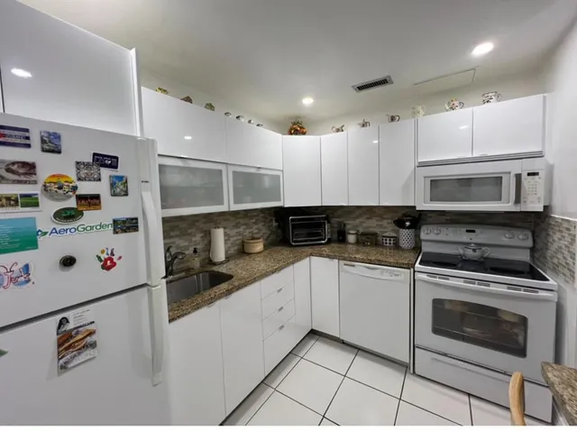 a bedroom with a bed a couch and dresser