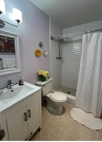 a bedroom with a bed and a lamp on table