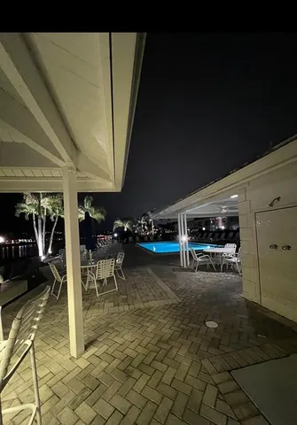 a living room with lots of furniture and a book shelf