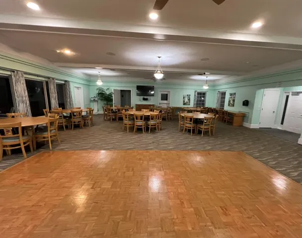 a patio with a table and chairs with potted plants