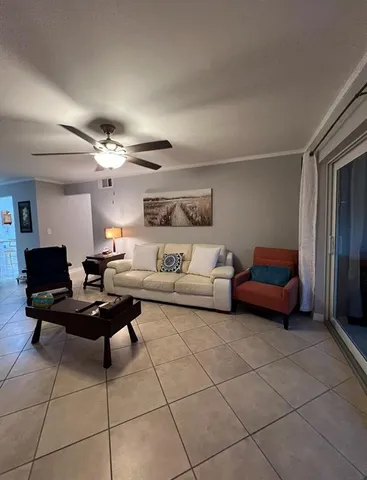 a living room with furniture a table and chairs
