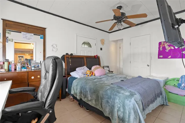 a bedroom with a bed a mirror and dresser