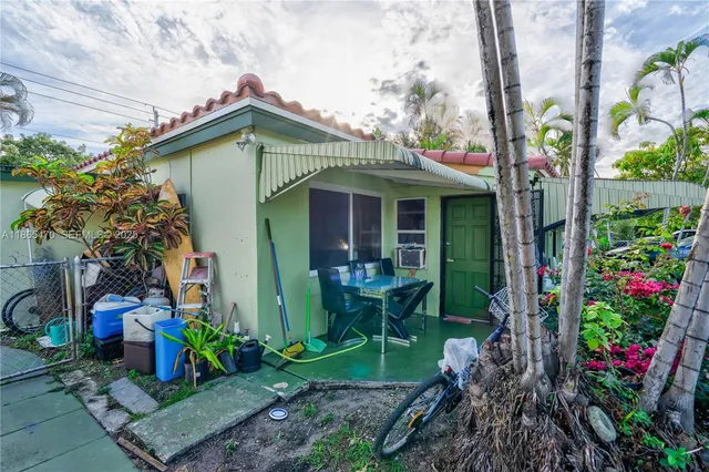 a view of a hallway with wooden floor and a bathroom