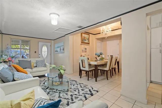 a view of a dining room with furniture and a chandelier