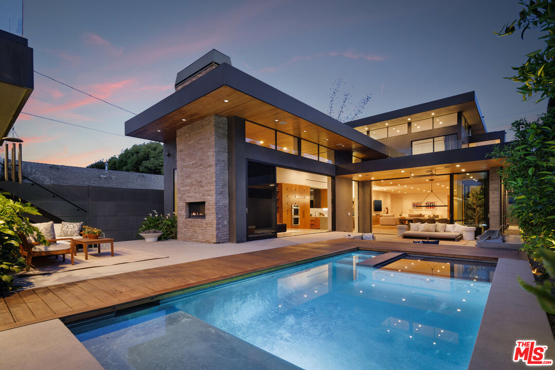 a swimming pool with outdoor seating and yard