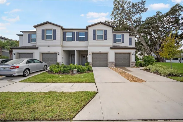a front view of a house with a yard and garage