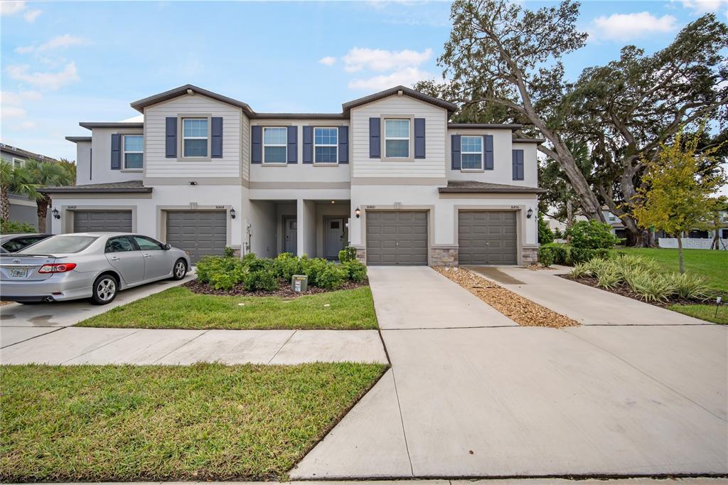 a front view of a house with a yard and garage