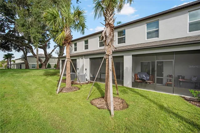 a view of a house with a yard patio and swimming pool
