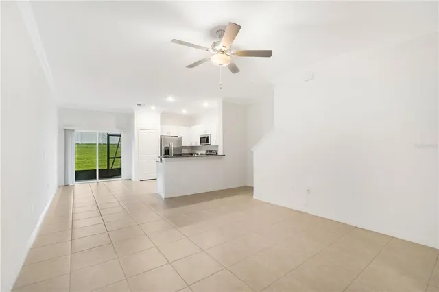 a view of an empty room with a kitchen