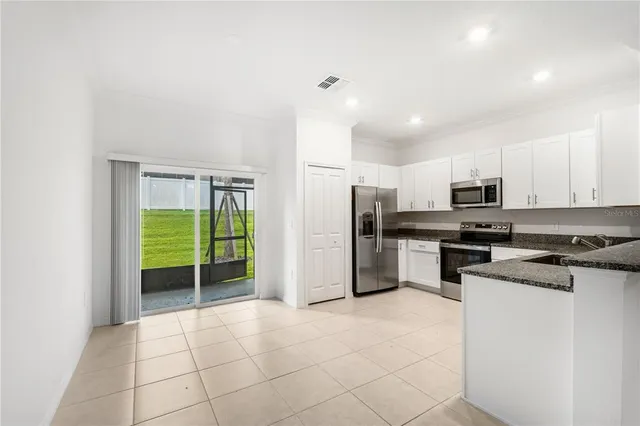 a kitchen with stainless steel appliances a refrigerator sink and stove