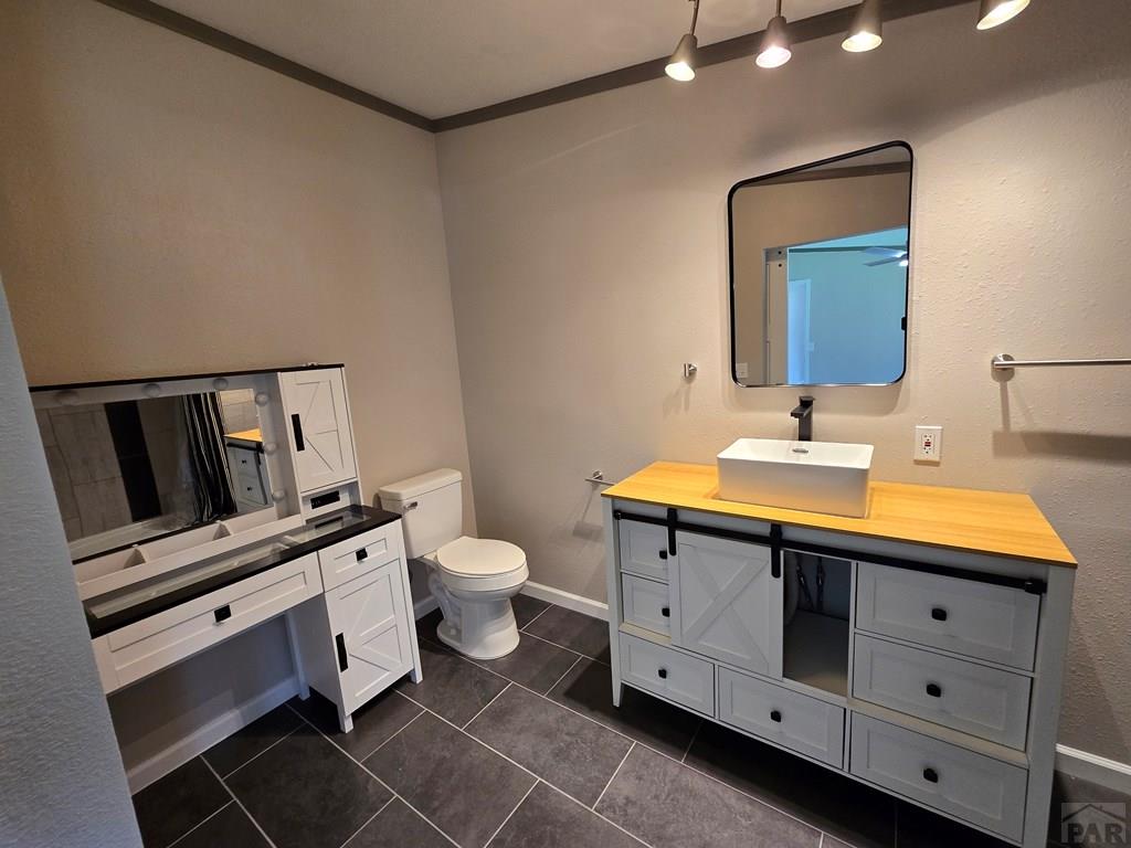 8229 Green Lane Rye, CO 81069 - Photo 12 of 24 a bathroom with a toilet sink and mirror