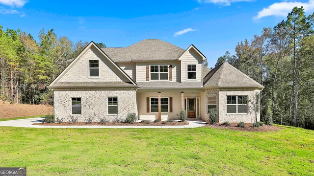 a front view of house with yard and green space
