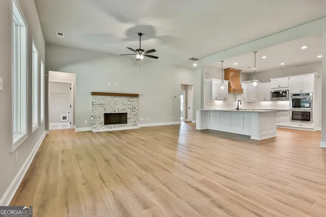 a view of a kitchen with wooden floor and a kitchen