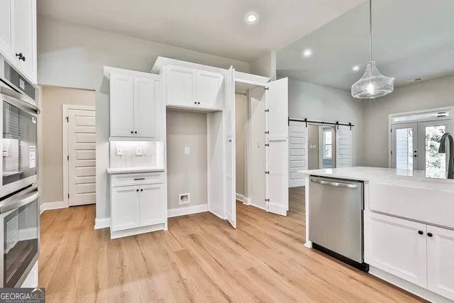 an empty room with windows and closet