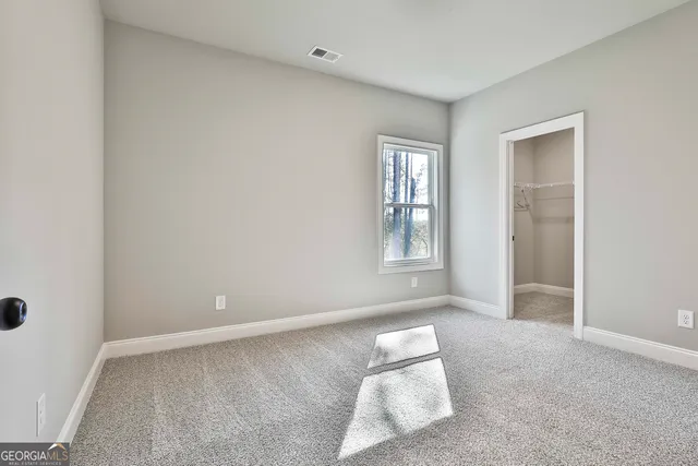 a bathroom with a sink a toilet a mirror and shower