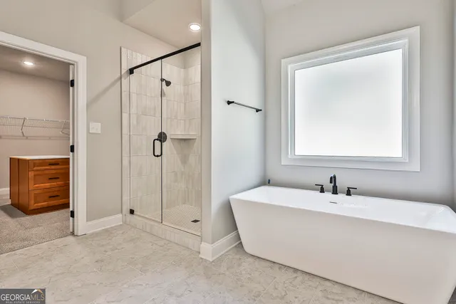 a bathroom with a bathtub and shower