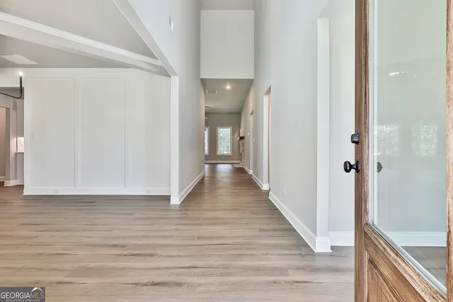 a view of a hallway with wooden floor