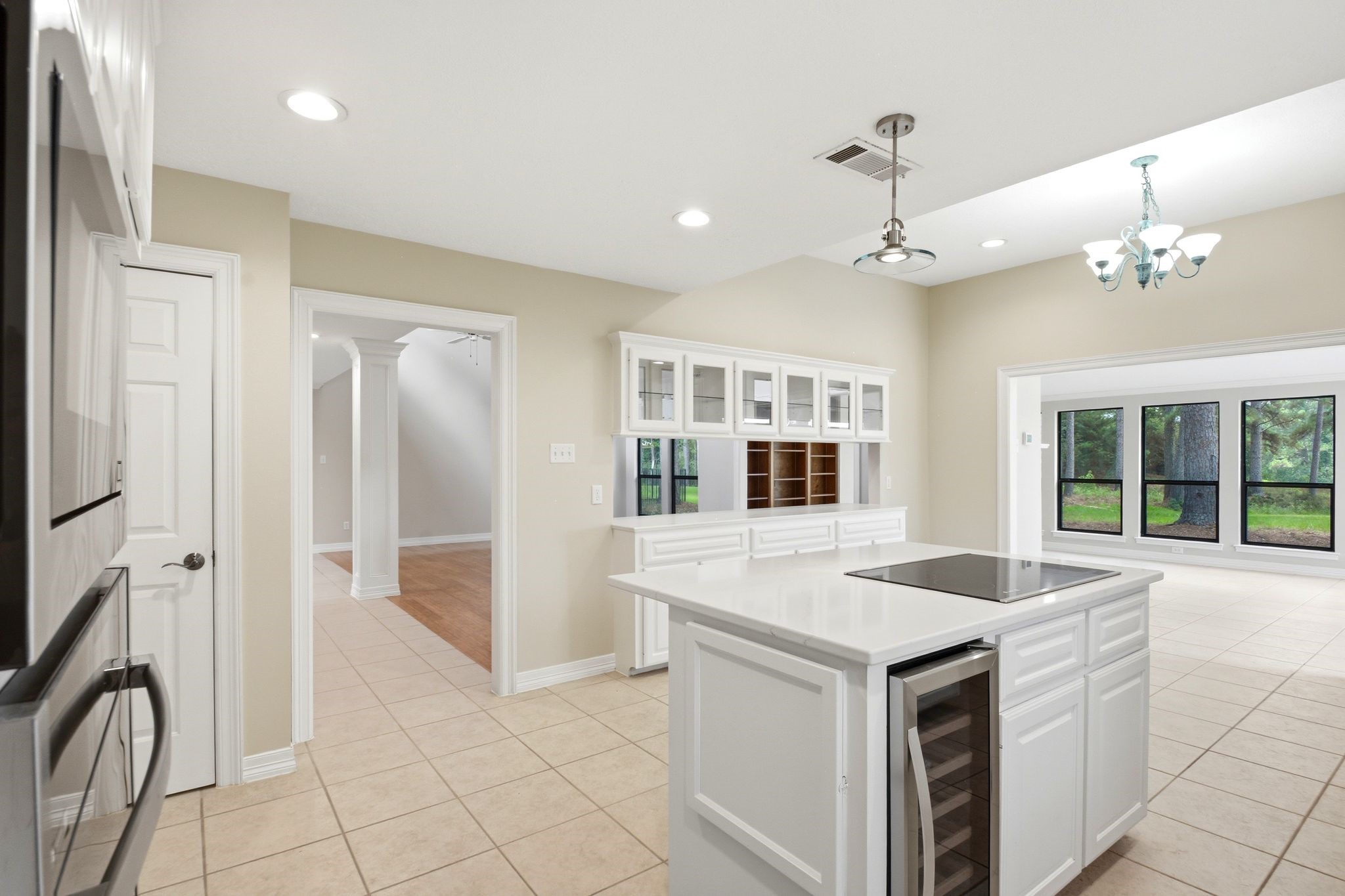22509 Pebble Beach Way Point Blank, TX 77364 - Photo 11 of 30 Center island with cooktop and built-in wine refrigerator