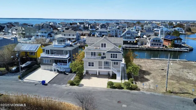 an aerial view of a house with a ocean view