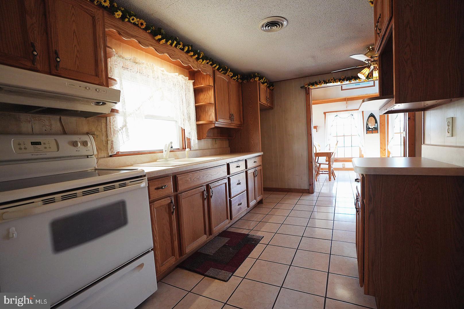 7 Princeton Avenue Fortescue, NJ 08321 - Photo 24 of 79 a kitchen with a stove sink and cabinets