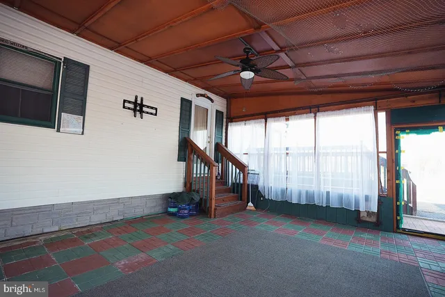 a view of a white house with large windows