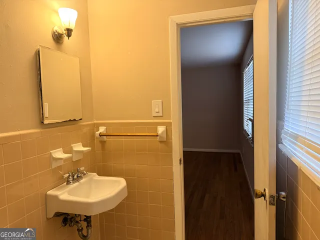 a bathroom with a sink a mirror and a toilet
