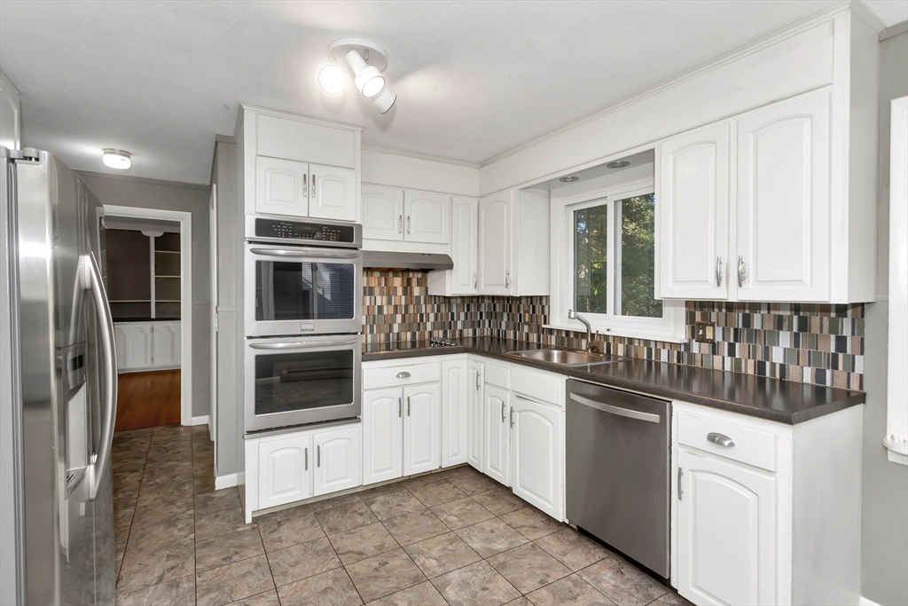 11 Longfellow Road Holyoke, MA 01040 - Photo 17 of 37 a kitchen with stainless steel appliances a white cabinet and a sink